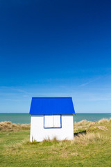 Colorful wooden beach cabins in the dunes, Gouville-sur-Mer, Normandy, France