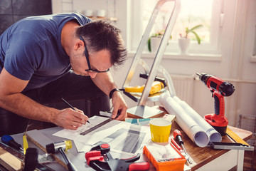 Men looking at blueprints during kitchen renovation