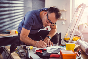 Men looking at blueprints during kitchen renovation