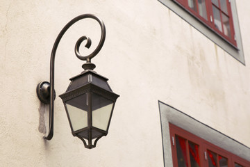 Fototapeta na wymiar vintage lantern on the wall of the house 