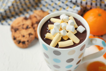 Fototapeta na wymiar Cup of hot chocolate with marshmallows on table