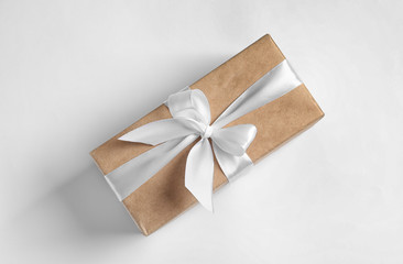 Beautifully wrapped gift box on white background, top view