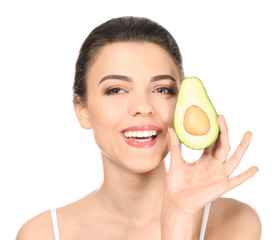 Beautiful young woman with avocado on white background