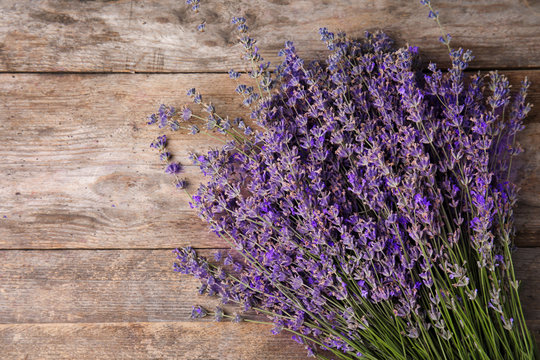 Lavender flowers on wooden background, top view