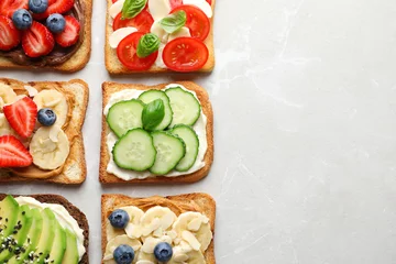 Poster Tasty toast bread with fruits, berries and vegetables on light background © New Africa