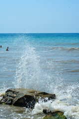 Sea waves break on stones