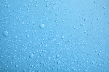 Many clean water drops on color background