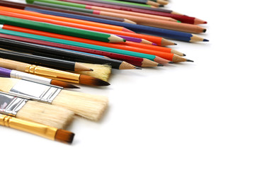 Fototapeta premium Brushes and pencils of professional artist on table, closeup