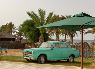 Old car on the beach background