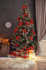 Stylish room interior with decorated Christmas tree