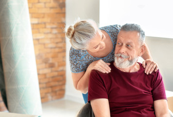 Happy mature couple indoors. Moving into new house