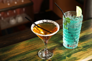 Glasses with delicious cocktails on counter in bar