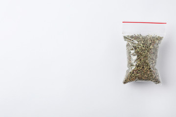 Plastic bag with spice on white background, top view