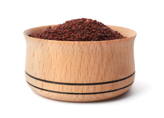 Wooden bowl with sumac on white background. Different spices