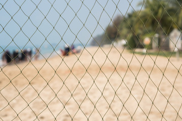 Football Net on the Beach with blurred people Background, Leisure Sport Activity in Summer Holiday