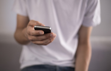 Young man using a touchscreen smartphone - Hands close-up - Using technology