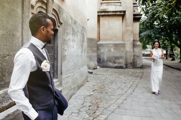 Wedding day. Stylish african groom and his pretty bride.