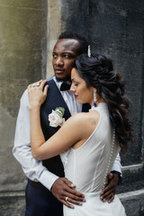 Wedding day. Stylish african groom and his pretty bride.