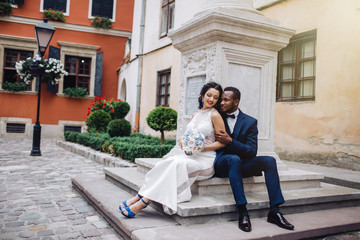 Wedding day. Stylish african groom and his pretty bride.