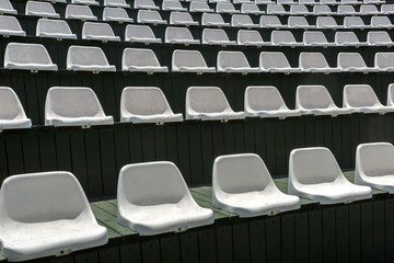 Fototapeta premium Rows of empty white chairs in the open summer hall for entertainment