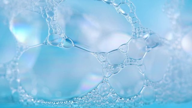 Foam. Soap foam popping bubbles background. Foam macro structure closeup. Washing concept. Slow motion 4K UHD video 3840x2160