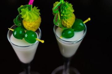 exotic drink based on Malibu rum and other ingredients, cocktail prepared by the bartender