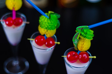 exotic drink based on Malibu rum and other ingredients, cocktail prepared by the bartender