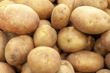 Pile of fresh organic potatoes top view close up.
