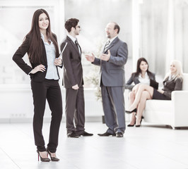 Manager of the company with documents on the background of the company's employees