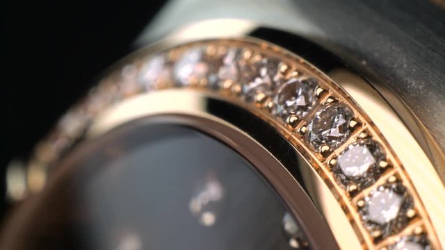 Luxury expensive fashion gold watches with sapphires and diamons.Arrows ticking. Close up 4k macro shot.