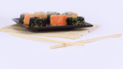 different types of Maki sushi on a black plate