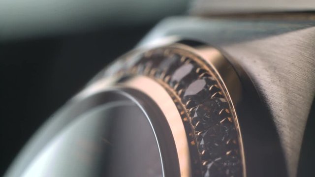 Luxury expensive fashion gold watches with sapphires and diamons.Arrows ticking. Close up 4k macro shot.
