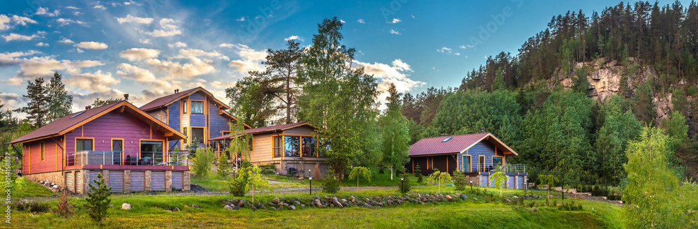 Wall mural Panorama of the village. Wooden houses. Cottages in the sky. Private houses outside the city.