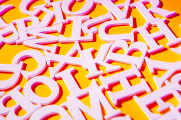 English font. Letters on a yellow background. White font.
