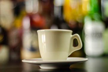 black coffee in a ceramic cup on the bar, energy drink in a public place