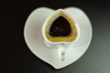 black coffee in a ceramic cup on the bar, energy drink in a public place