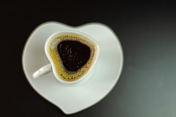 black coffee in a ceramic cup on the bar, energy drink in a public place