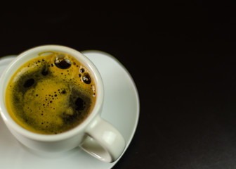 black coffee in a ceramic cup on the bar, energy drink in a public place