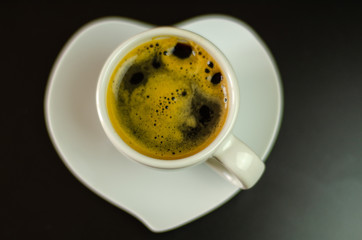 black coffee in a ceramic cup on the bar, energy drink in a public place
