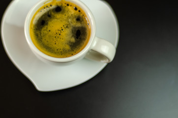 black coffee in a ceramic cup on the bar, energy drink in a public place