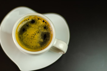 black coffee in a ceramic cup on the bar, energy drink in a public place