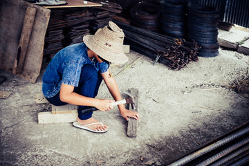 Little girl labor working in commercial building structure, World Day Against Child Labour concept.