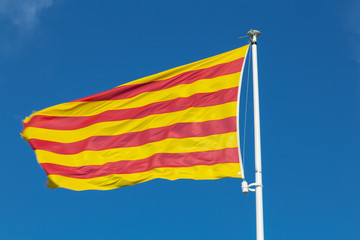 flag of spain extendedica with a blue sky in the background