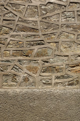 Old stone wall with cemented elements