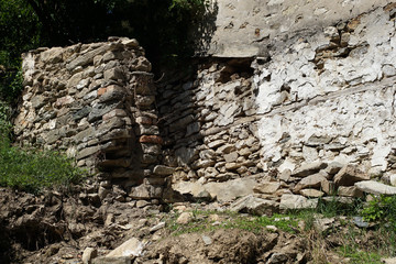 Old stone wall with wild herbs growing out of them