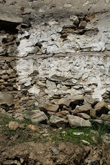 Old stone wall with cemented elements
