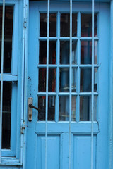 Old blue color metal industrial fence & door shades