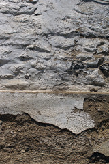 Old stone wall with cemented elements