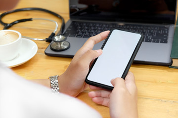 Cropped shot of hands of a doctor holding and touching screen of mobile phone