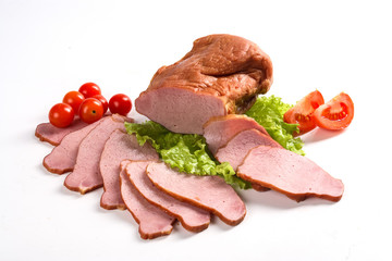 Slised ham with vegetables. Still life.